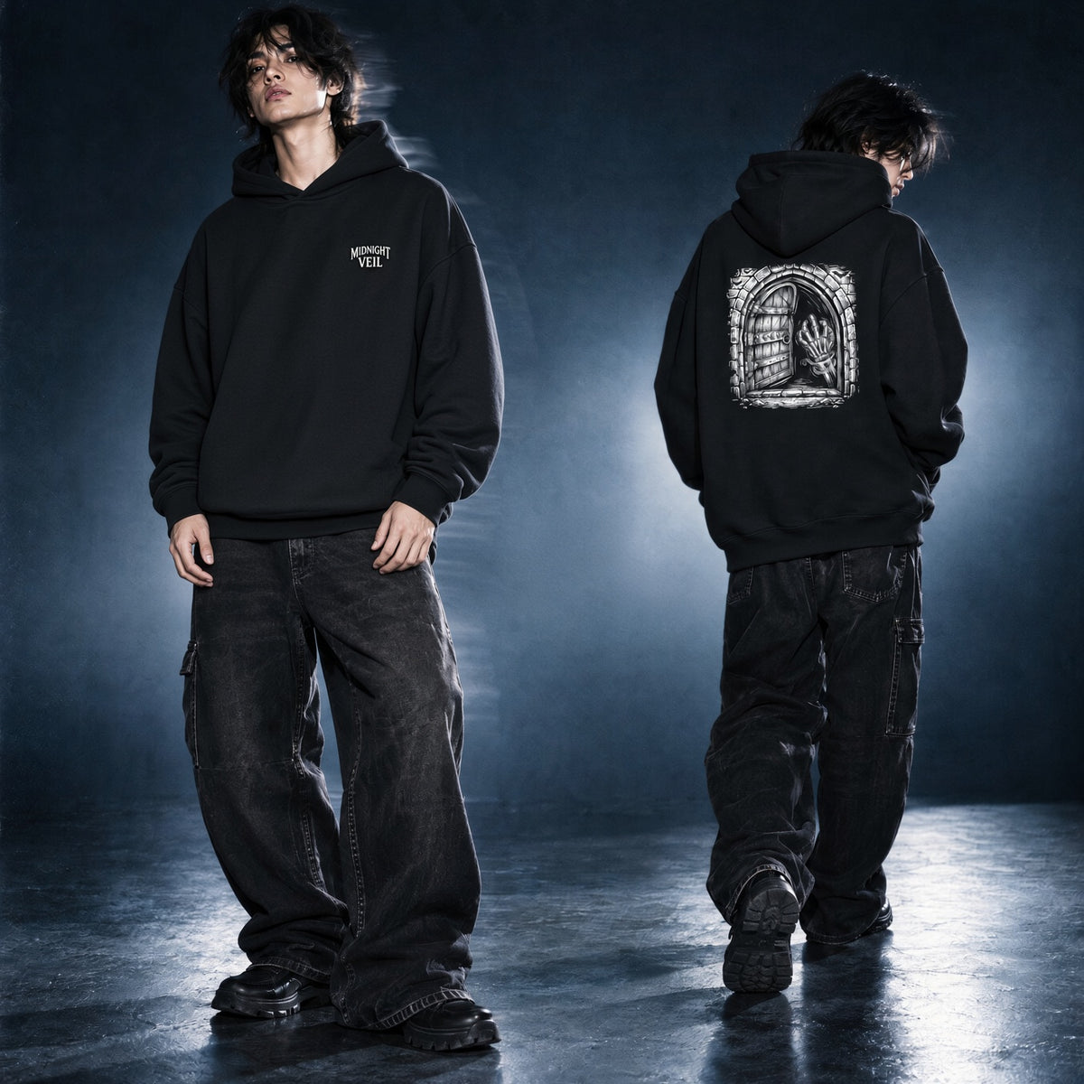 A model is shown from the front and back wearing a black pullover hoodie with graphic prints. The front view shows a small white chest graphic, while the back view shows a large white gothic-style graphic of a hand inside a window frame.