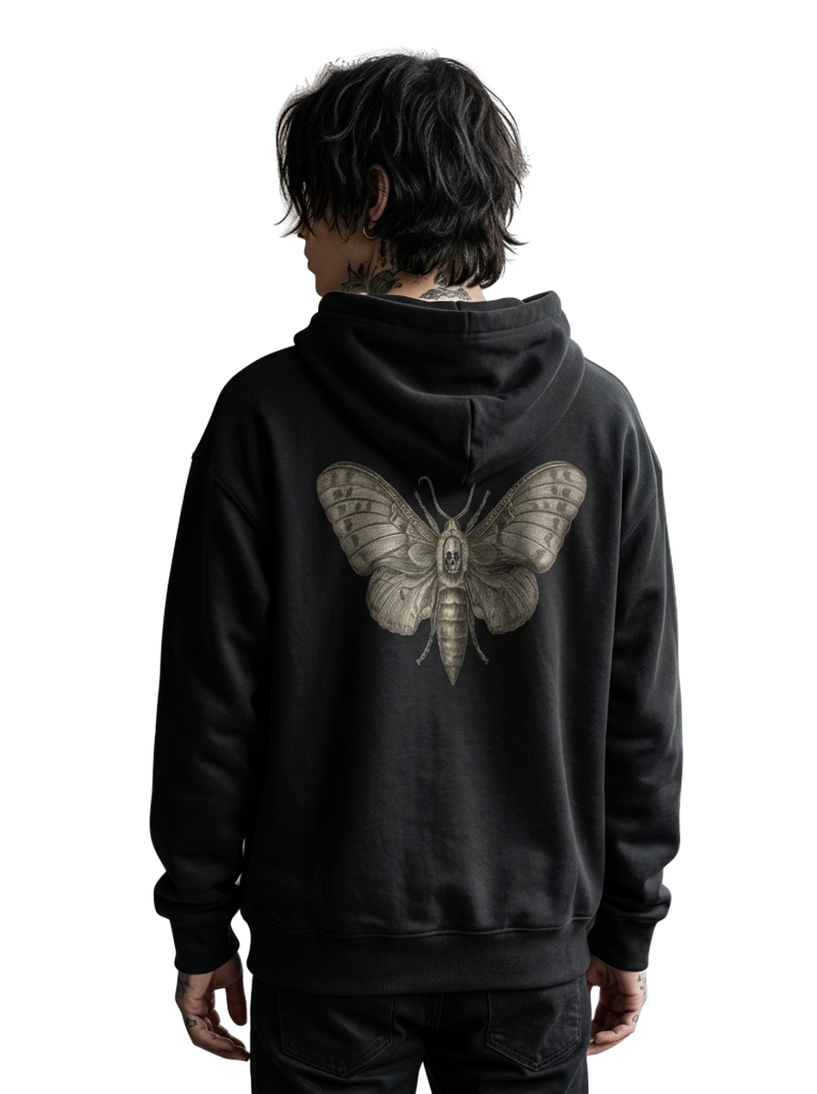 A person shown from the back wearing a black hoodie with a large detailed moth graphic printed on the back