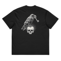 Back of a black heavyweight box tee with a bone raven, key, and skull print