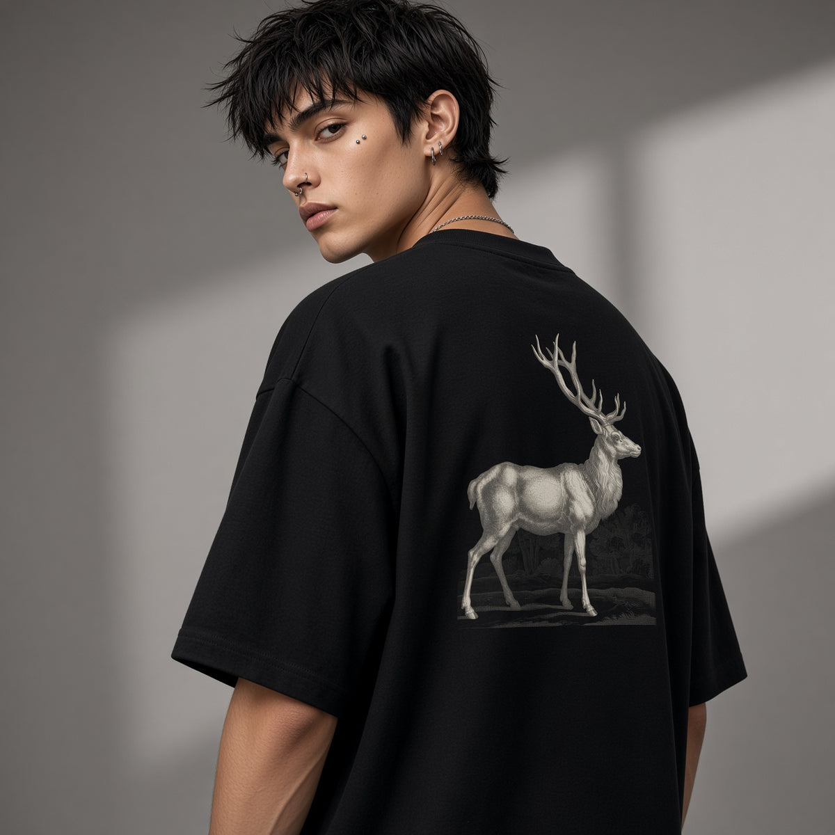 Back of a black box tee with a bone stag print, worn oversized