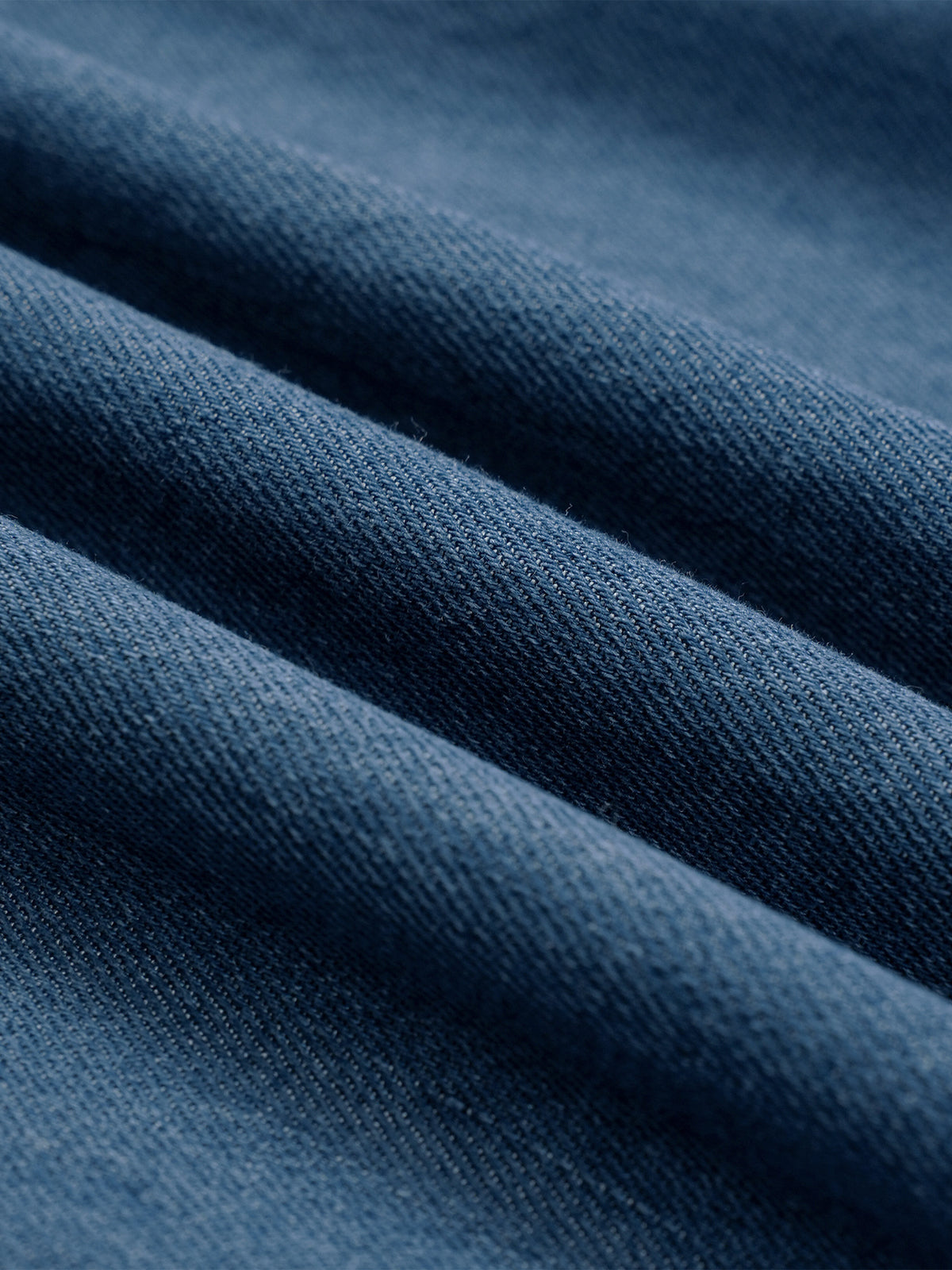 Close-up of the light blue vintage wash denim fabric texture on kids jeans