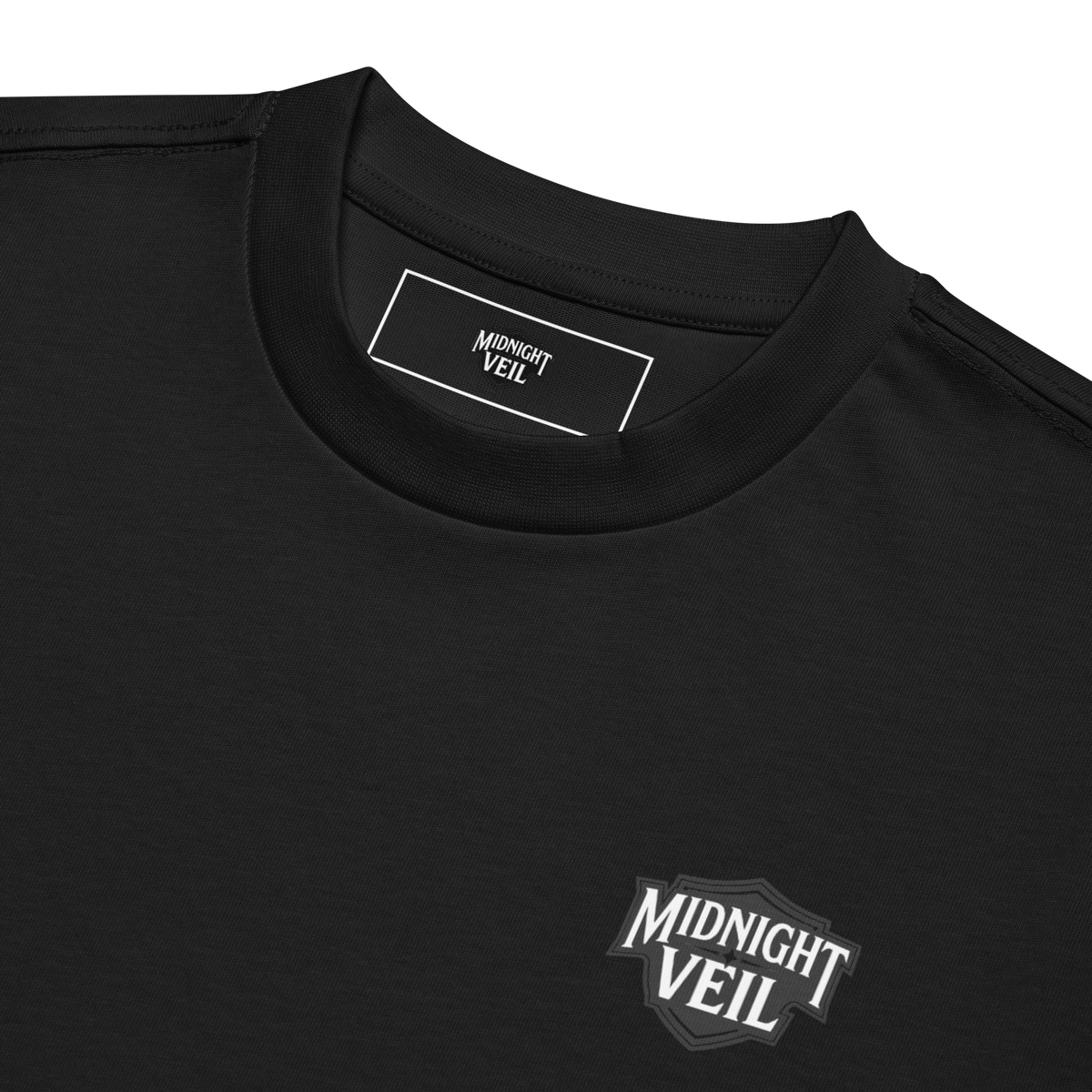 Close-up of the collar and chest mark on a black heavyweight box tee