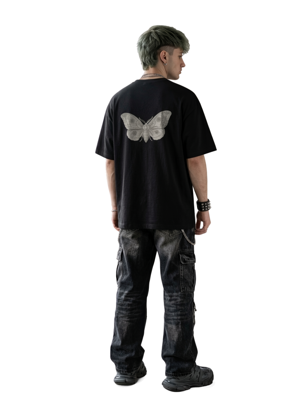 A person shown from the back wearing an oversized black T-shirt with a large light gray butterfly graphic on the back, paired with dark washed cargo pants and black shoes.