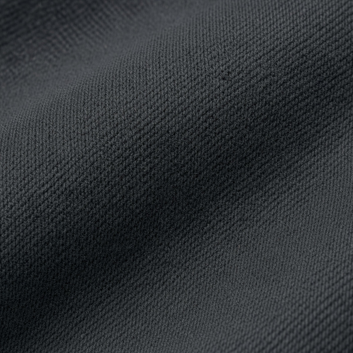 Macro close-up photography of the premium 15oz 500GSM organic cotton loopback cross-weave fleece fabric texture on the Midnight Veil Obsidian Black Outer Shroud hoodie.
